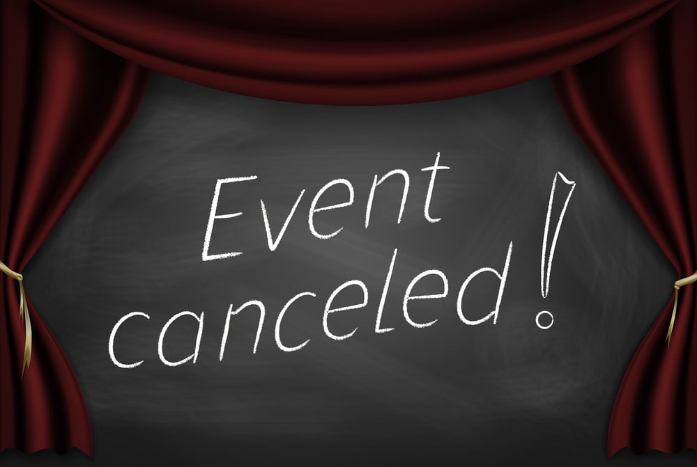 Event Cancelled written on a chalkboard surrounded by a banner