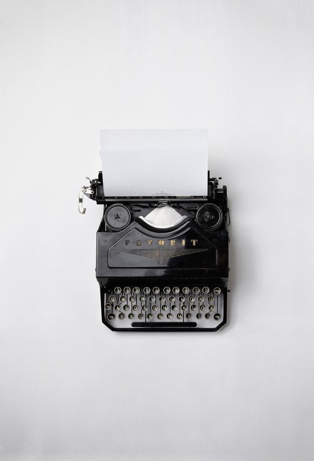 black typewriter on a white table
