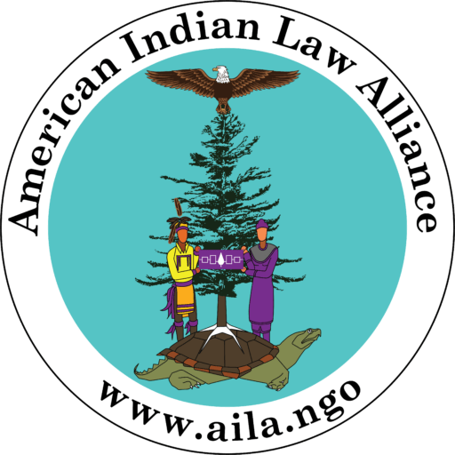 The American Indian Law Alliance logo is an eagle resting on the great tree of peace and the white roots of peace. The tree rests on the back of Turtle Island. A Haudenosaunee man and woman stand in front of the the tree holding the Hiawatha Belt.